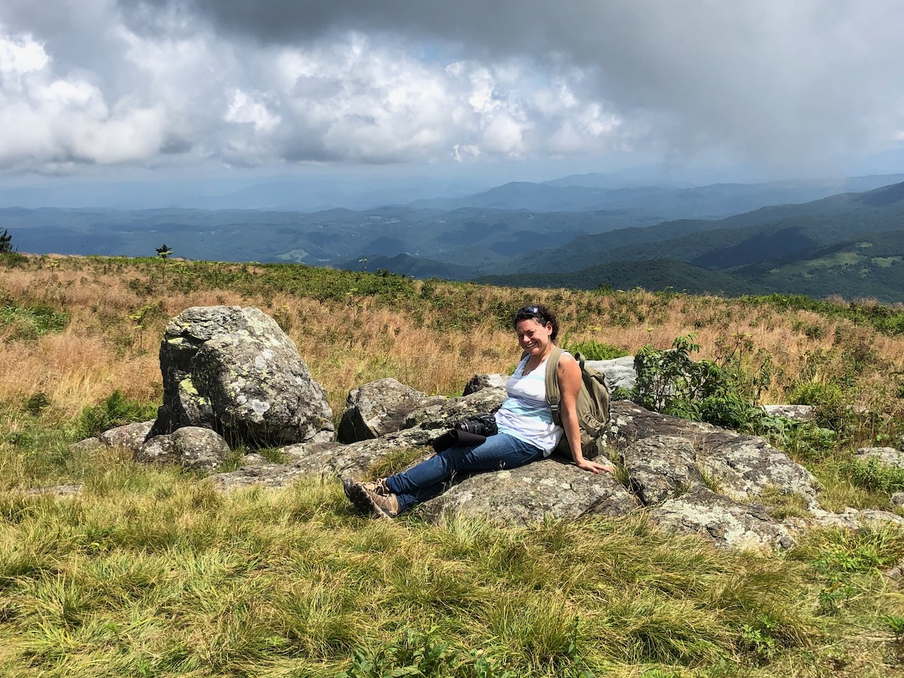 Meryl resting on rocks above the Southern Appalachian mountains